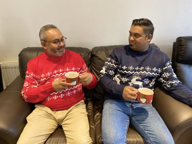 Two people sitting down drinking tea